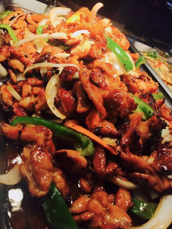 Spicy chicken stir-fried with peppers and onions