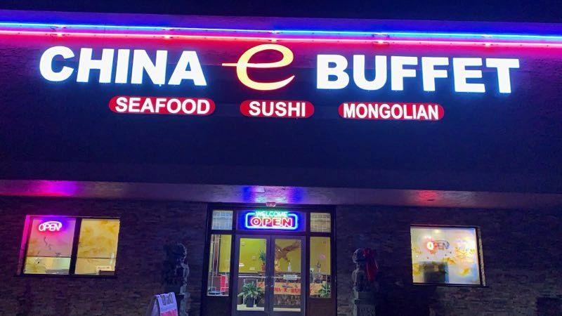 The China E Buffet sign lit up at night above the front entrance